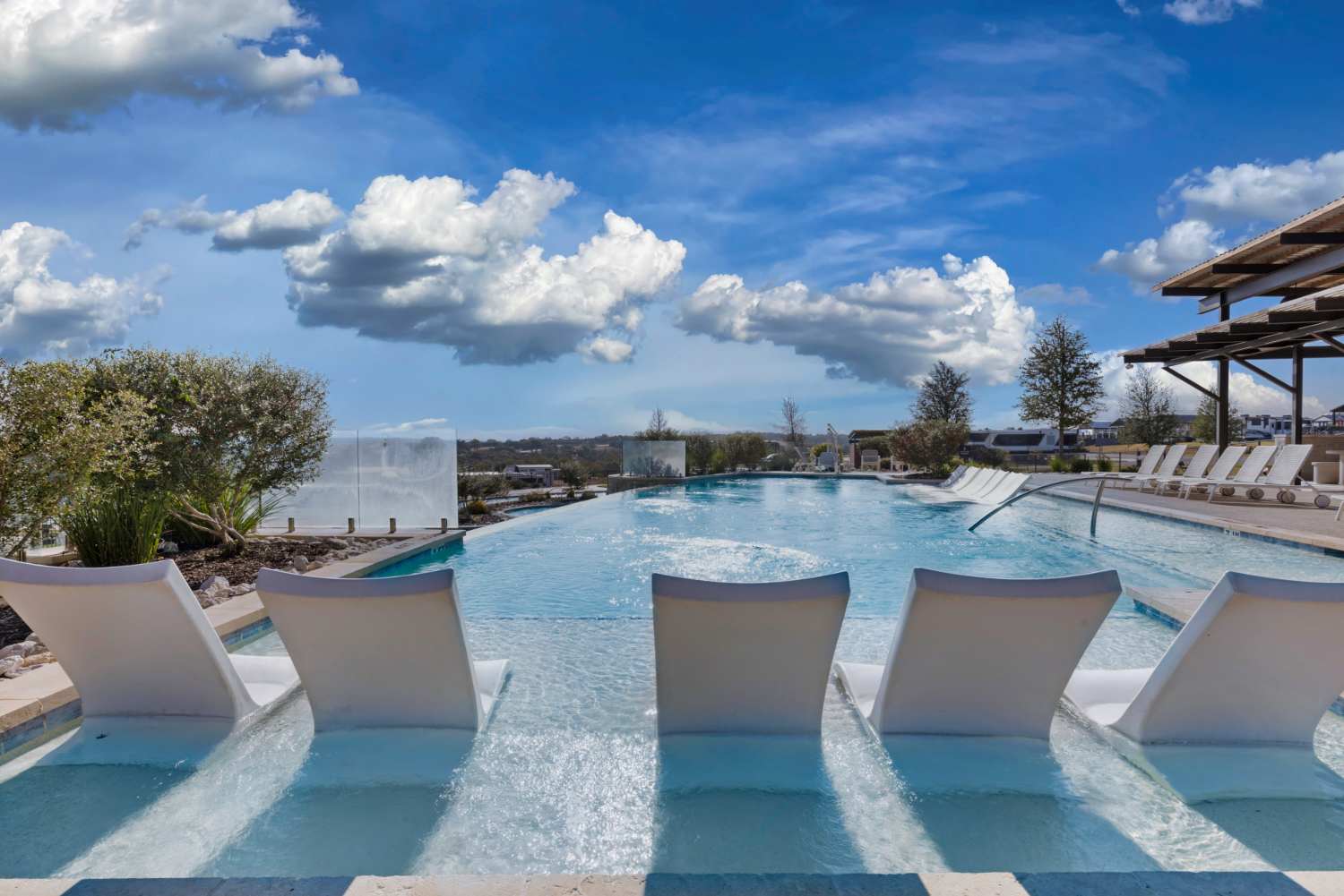 Tanning ledge with lounge chairs in the shallow water