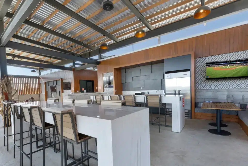 Bar seating under the covered pavilion roof with pendant lights